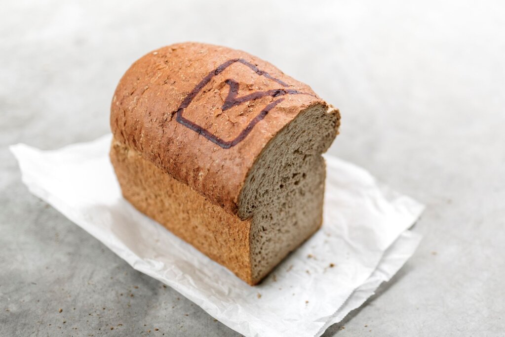 Cut loaf of bread with a checkmark in a square of baked RudinJet paste