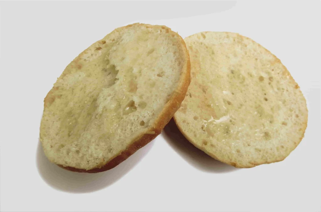 Two bun halves with the cut surface facing up, for the oil depositing application