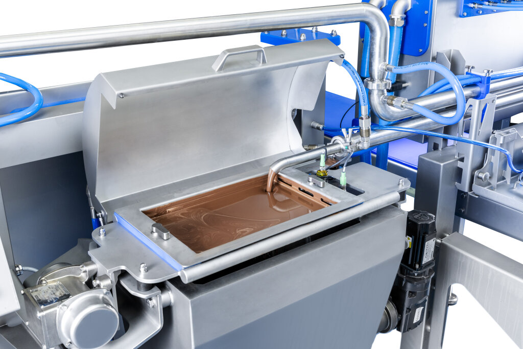MDSUW depositor with the lid of its heated supply tank open and warm material inside
